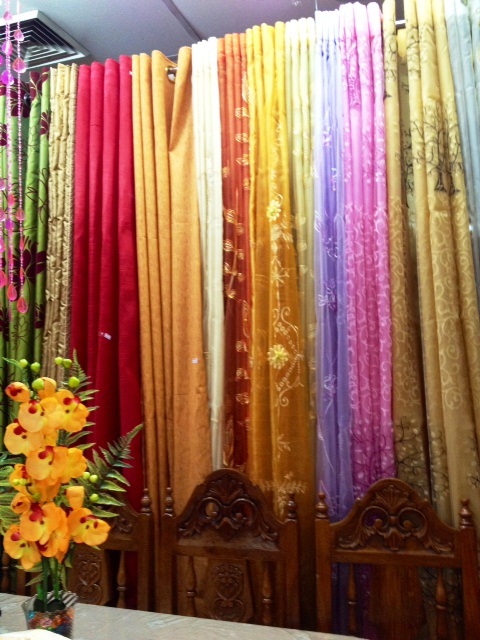 Multi-color curtains of different textures and fabrics provide an attractive contrast