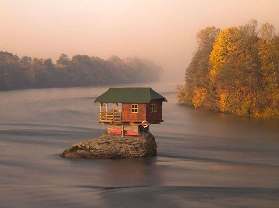 Tiny house sitting on a rock