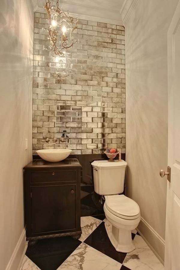 wall covered with metallic subway tile to this windowless bathroom
