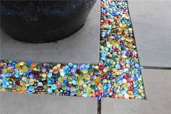 Colored glass being used to fill the gap between paving stones