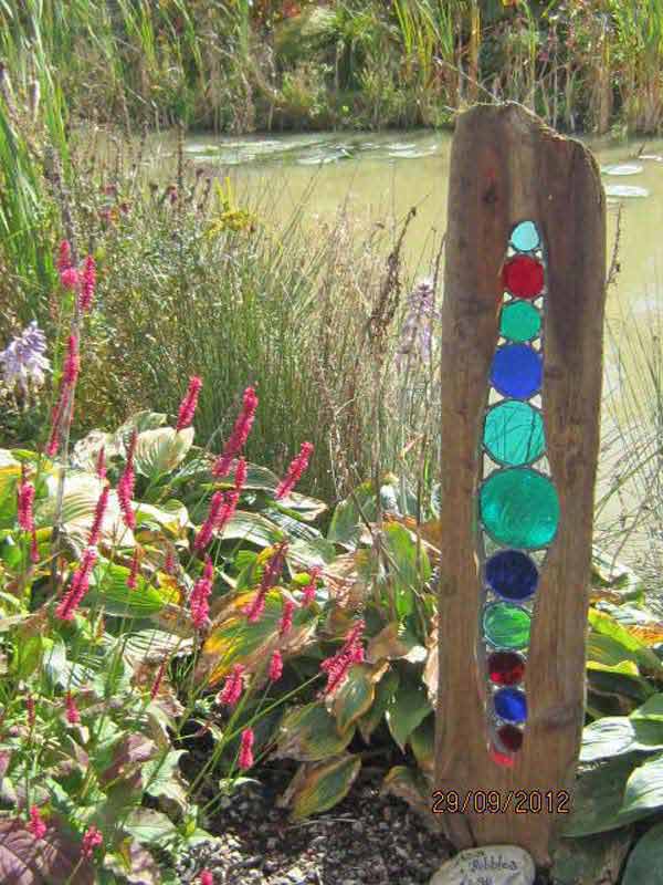 Driftwood and colored glass garden sculpture
