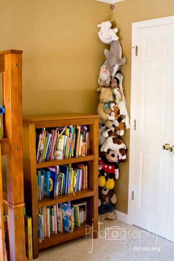 Hang a rope from the ceiling then clip the stuffed animals to it with clothes pins.