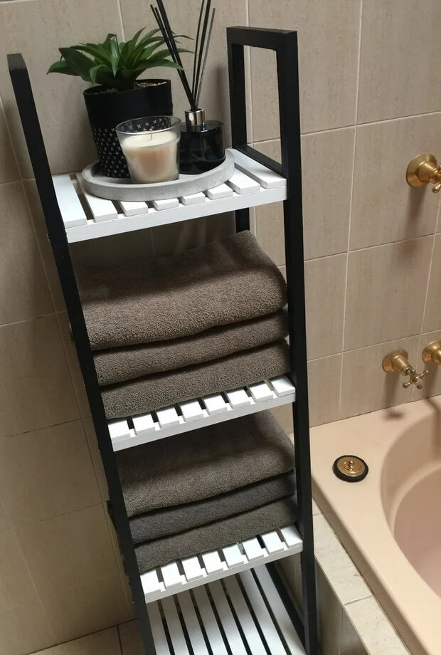 A bathroom shelf with black and white color