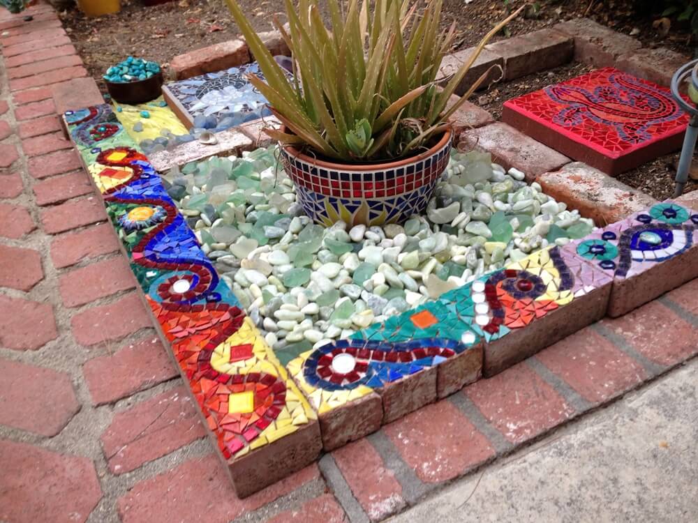 Decorate Bricks with Mosaics and Then Use For Making Garden Bed Borders
